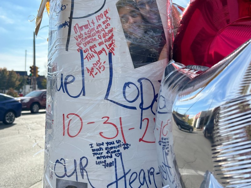 Balloons, photos and messages next to a street