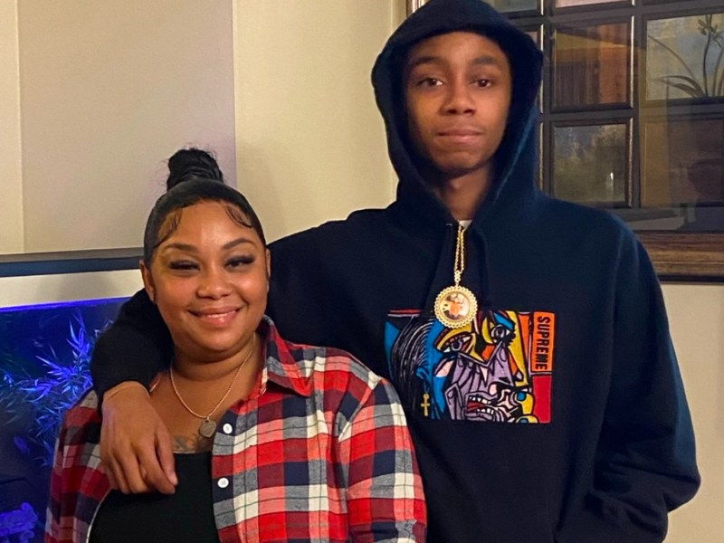 Smiling woman at left and young man in hoodie