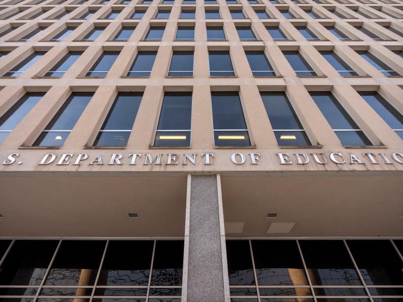 Rows of windows on a building above a U.S. Department of Education sign